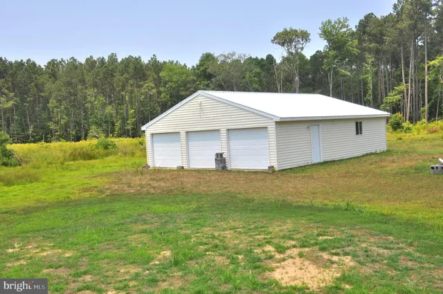 a view of a backyard with a garden and entertaining space