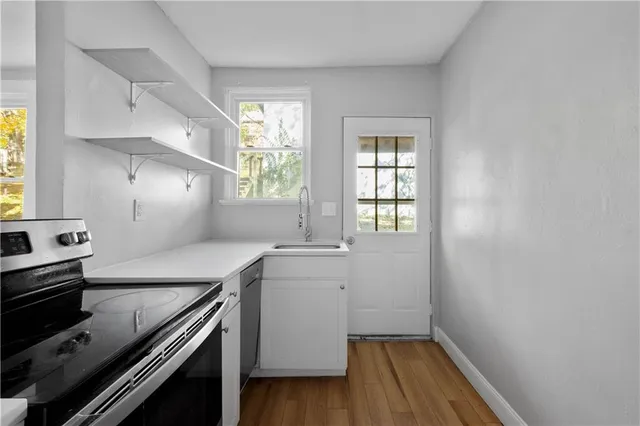 a kitchen with a sink stove and cabinets