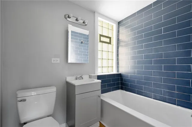 a bathroom with a toilet a sink and bathtub