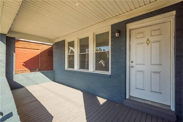 a balcony view with a wooden floor and windows