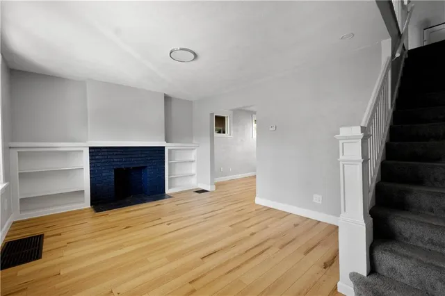 a view of an empty room and wooden floor