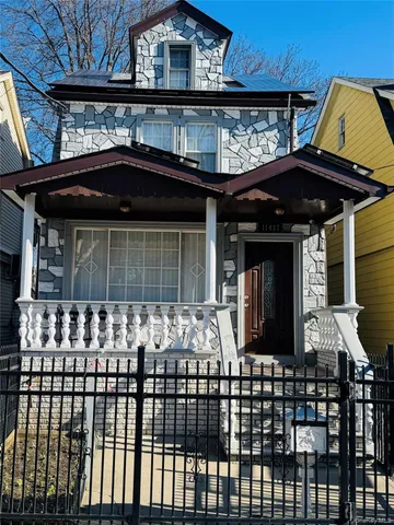 a front view of a house with large windows