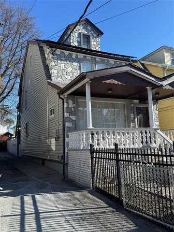 a view of a brick house with large windows