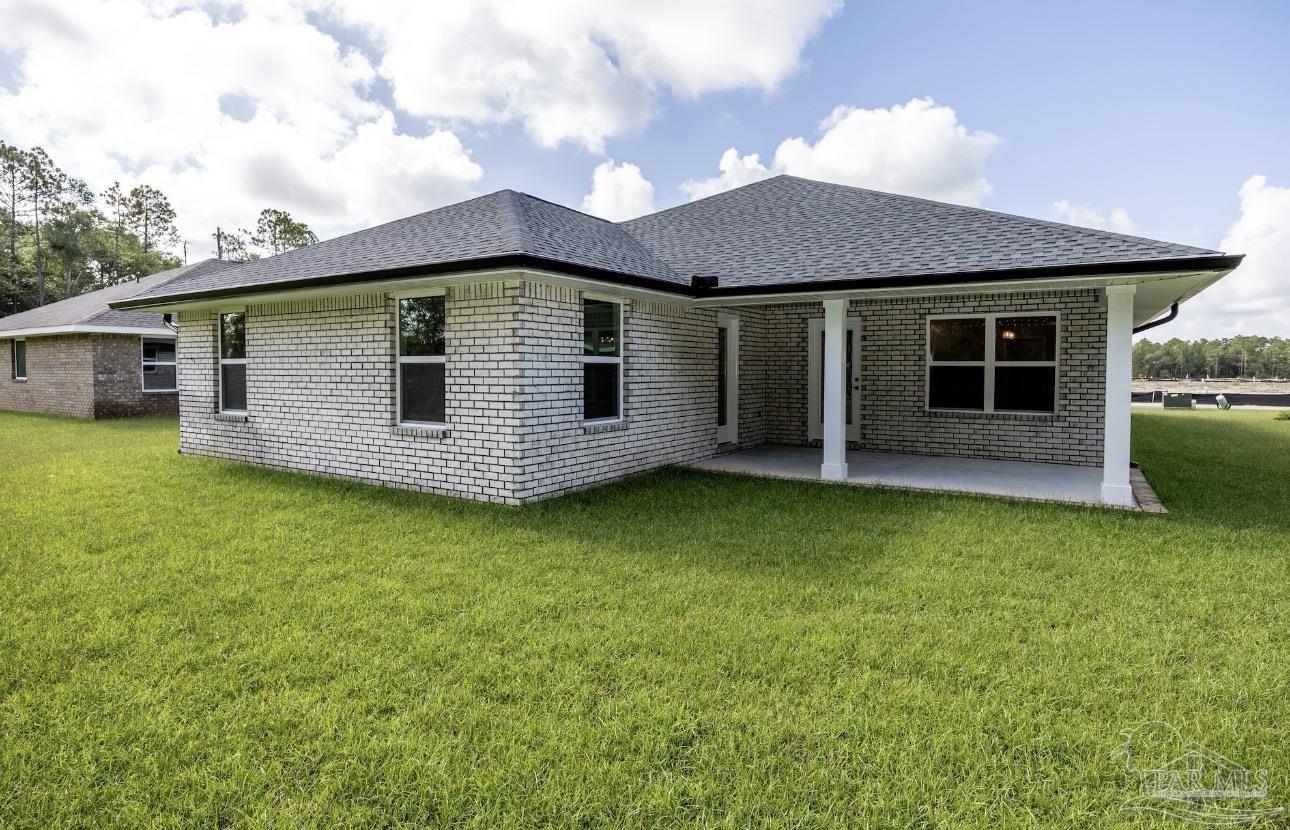 7657 Small Pnes Street Milton, FL 32583 - Photo 25 of 26 a front view of a house with garden