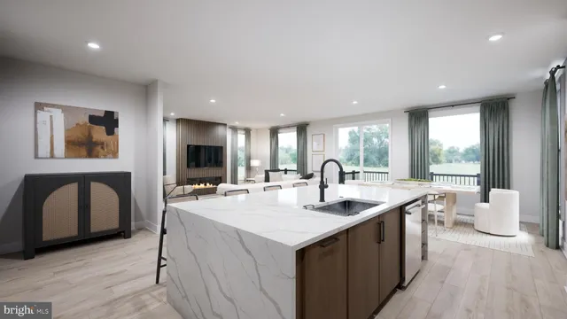 a kitchen with stainless steel appliances kitchen island granite countertop a table chairs sink and cabinets