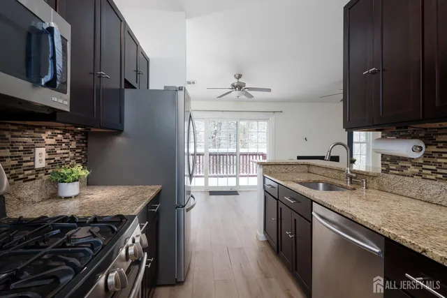a kitchen with stainless steel appliances granite countertop a stove and a sink