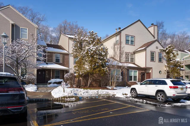 a white building that has a tree in front of it