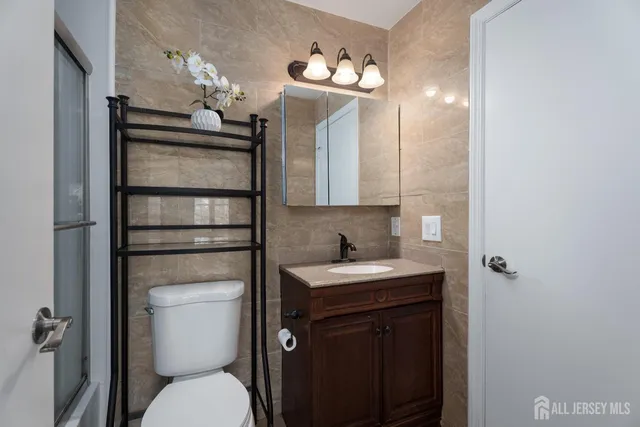 a bathroom with a toilet sink and mirror