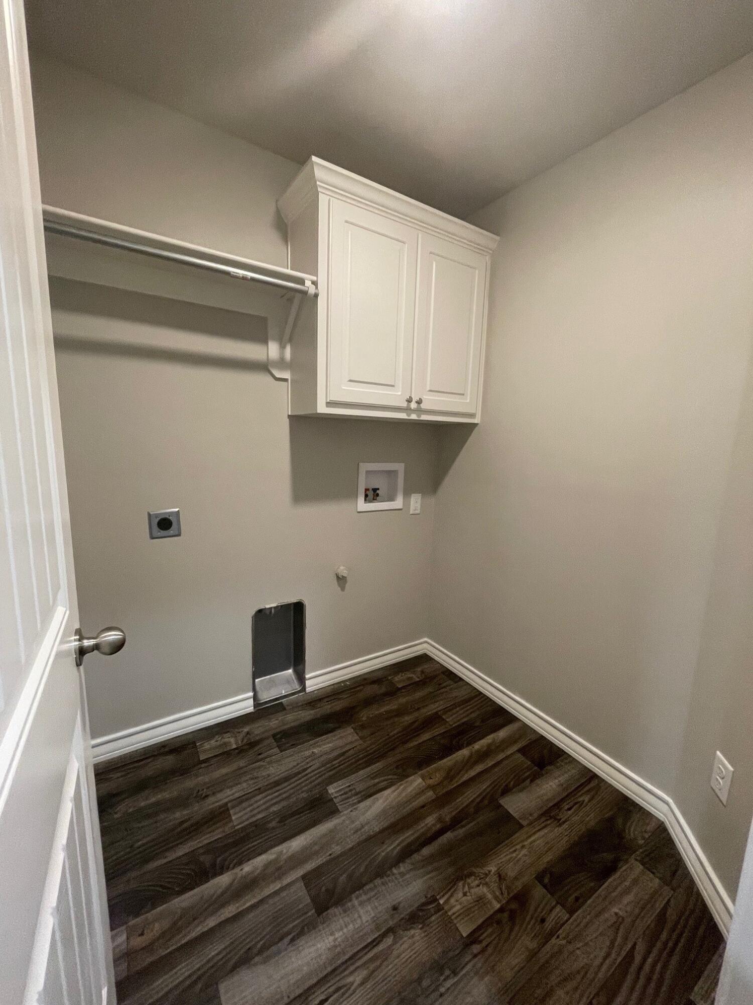6040 24th Street, Unit 35 Lubbock, TX 79407 - Photo 12 of 15 a room with a wooden floor and cabinets