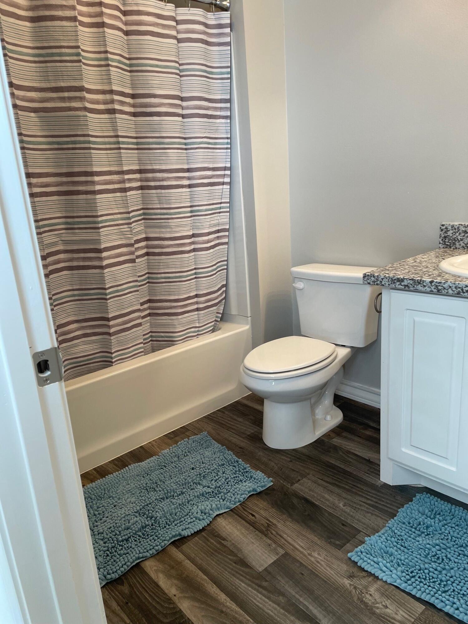 6040 24th Street, Unit 35 Lubbock, TX 79407 - Photo 10 of 15 a bathroom with a toilet and a shower