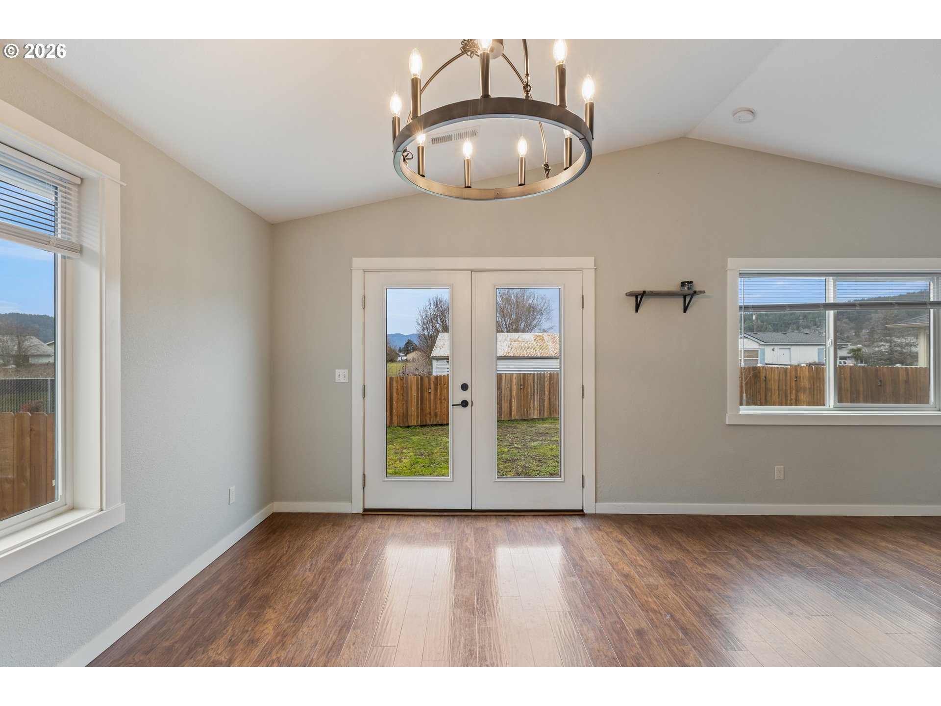 409 South State Street Sutherlin, OR 97479 - Photo 12 of 47 an empty room with wooden floor and windows