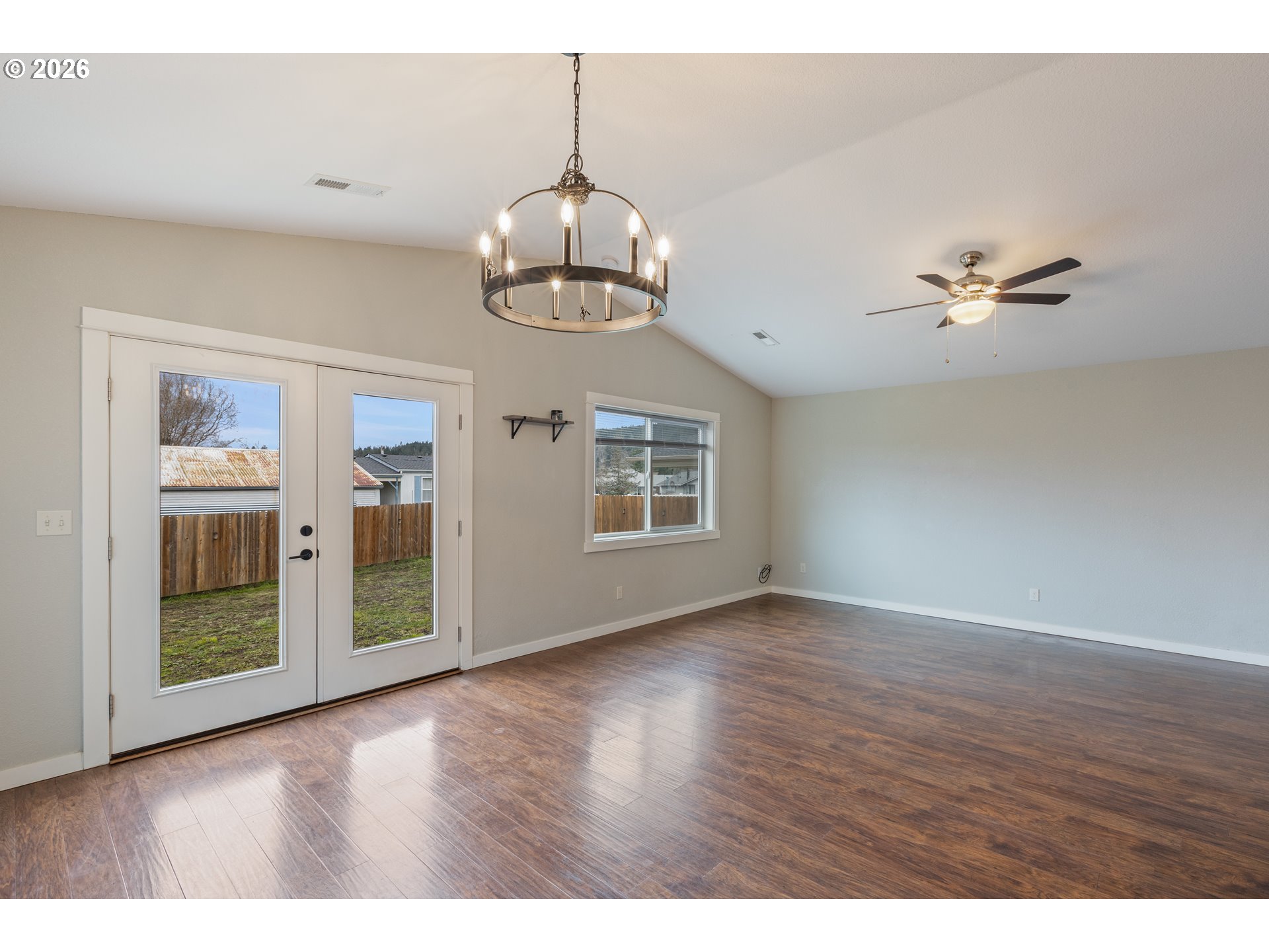 409 South State Street Sutherlin, OR 97479 - Photo 13 of 47 a view of an empty room with a window and wooden floor