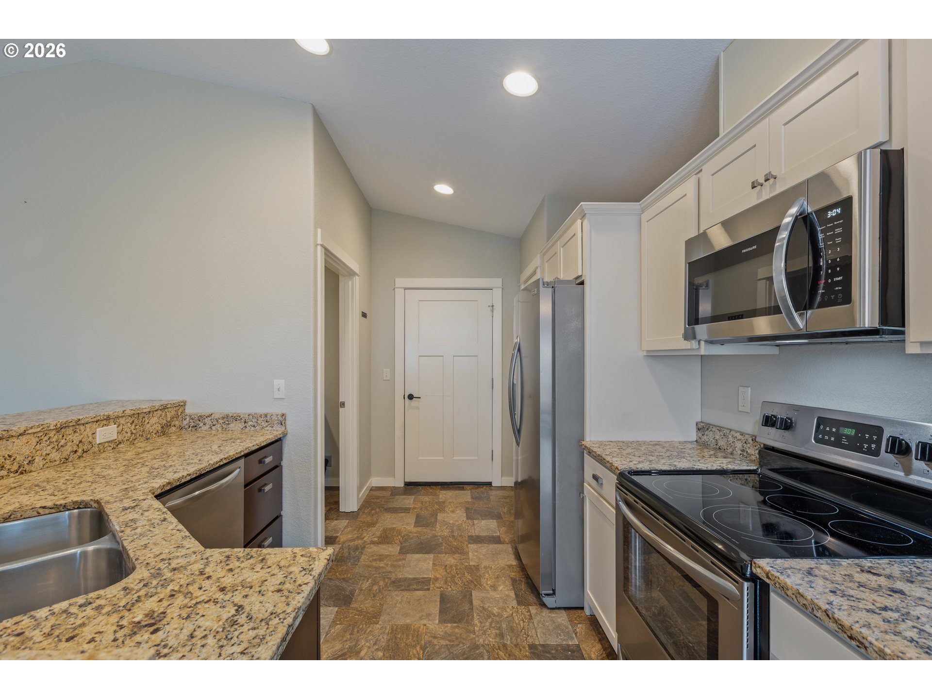 409 South State Street Sutherlin, OR 97479 - Photo 16 of 47 a kitchen with stainless steel appliances granite countertop a sink stove and microwave