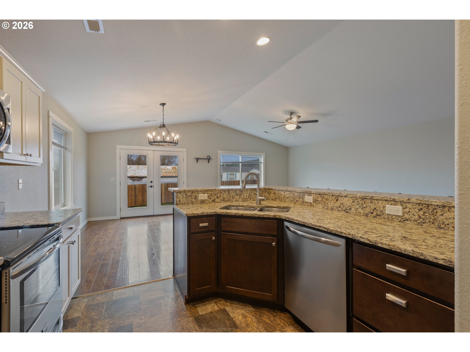 409 South State Street Sutherlin, OR 97479 - Photo 19 of 47 a kitchen with granite countertop a sink cabinets and stainless steel appliances