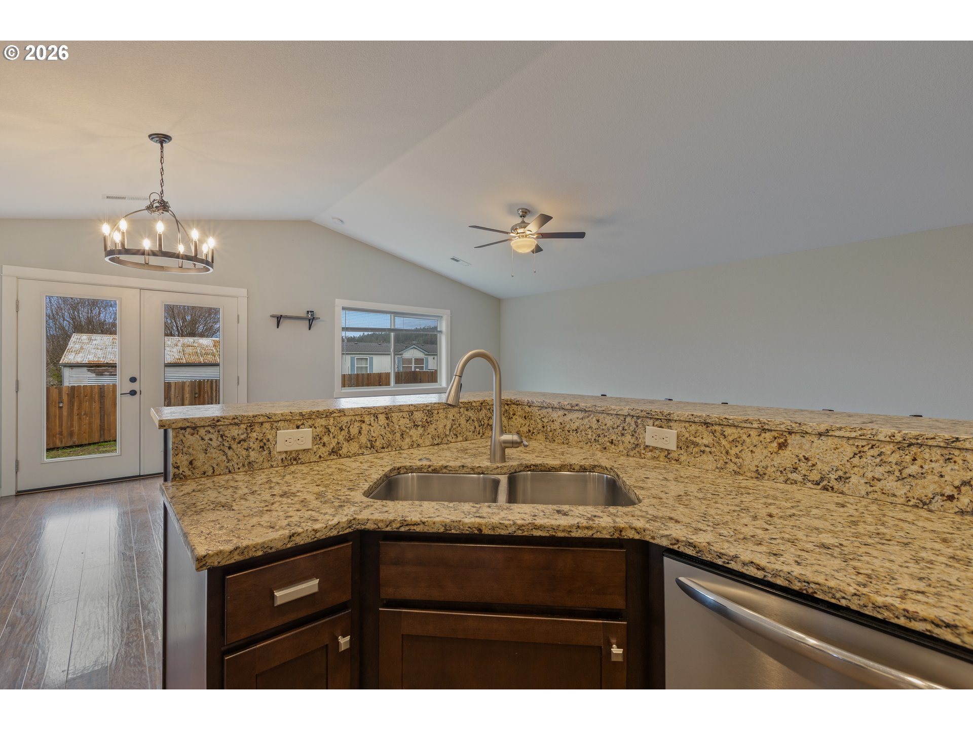 409 South State Street Sutherlin, OR 97479 - Photo 20 of 47 a view of kitchen island a sink wooden floor and kitchen view