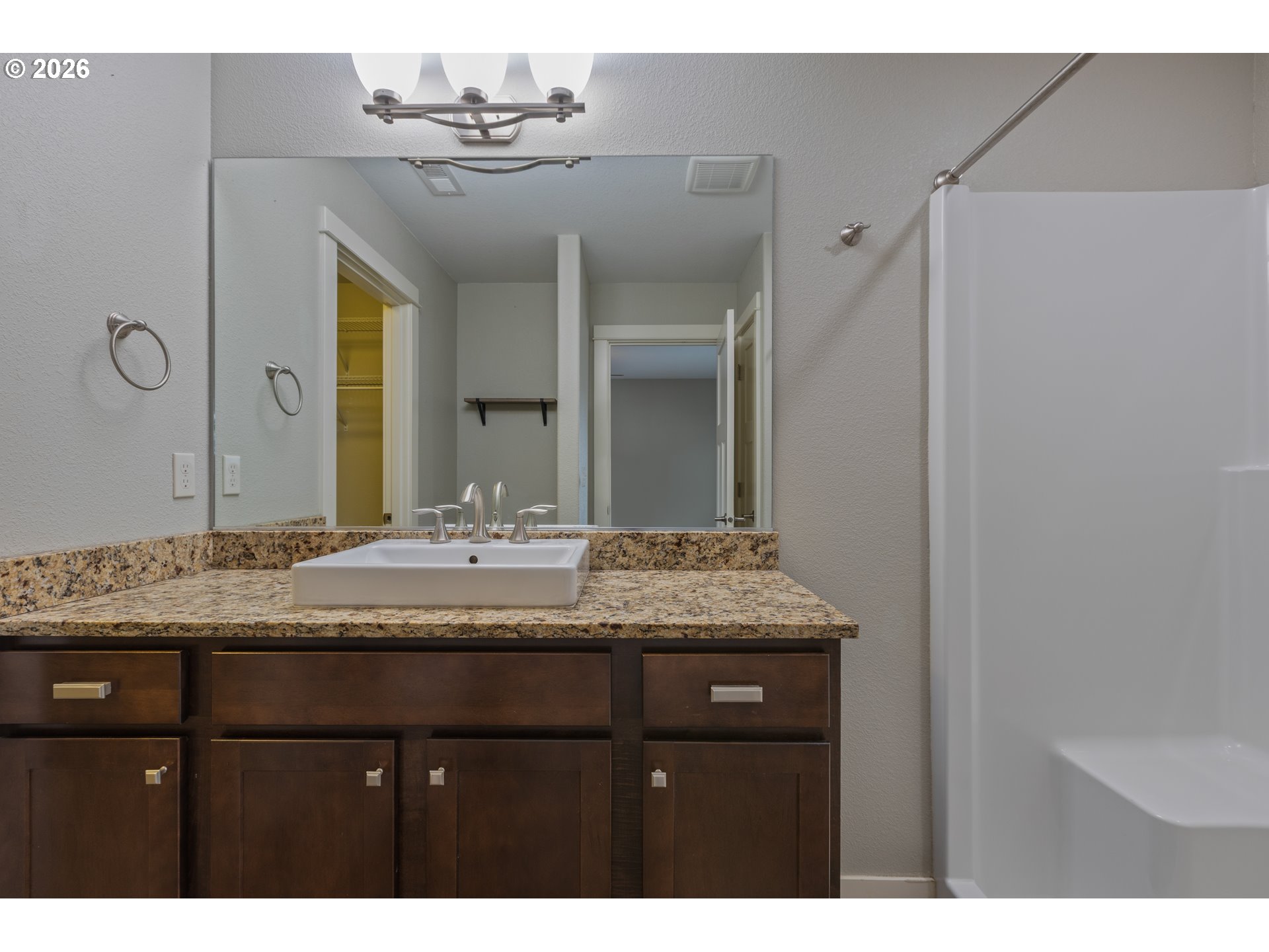 409 South State Street Sutherlin, OR 97479 - Photo 26 of 47 a bathroom with a granite countertop sink and a mirror