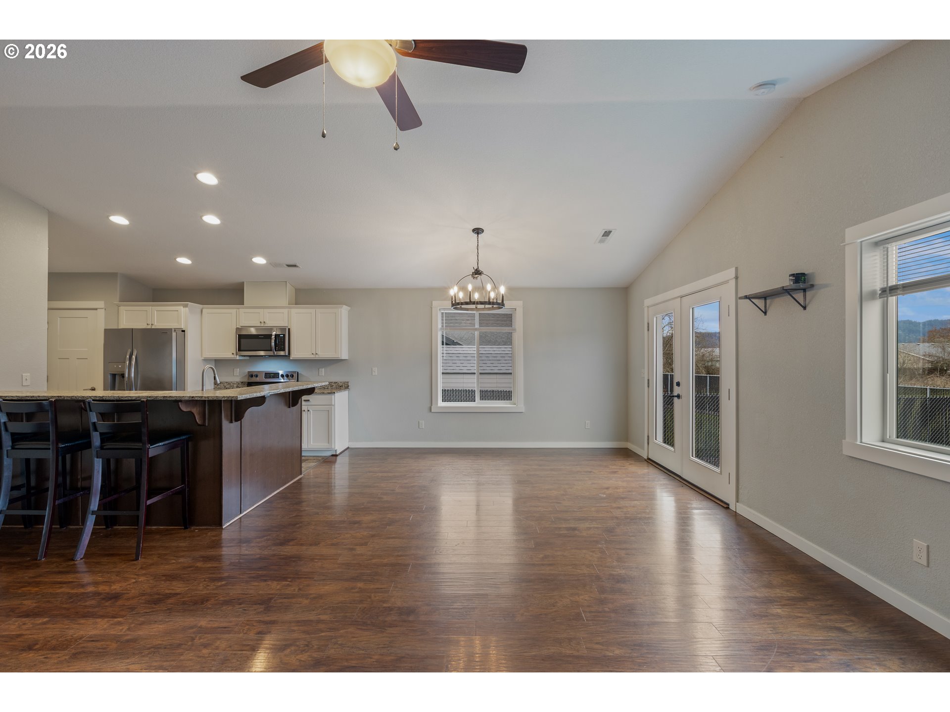 409 South State Street Sutherlin, OR 97479 - Photo 7 of 47 a view of kitchen with kitchen island granite countertop a stove top oven a sink a counter space and cabinets