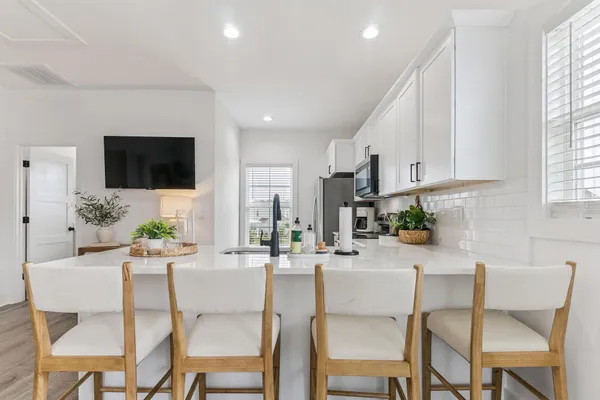a dining room with furniture a window and a kitchen view