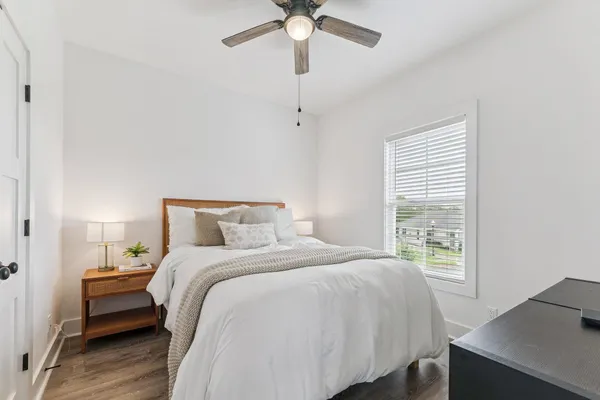 a bedroom with a bed and a window