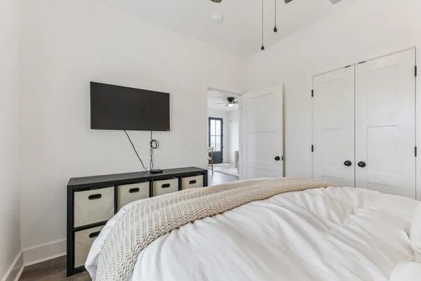 a bedroom with a bed and a flat screen tv