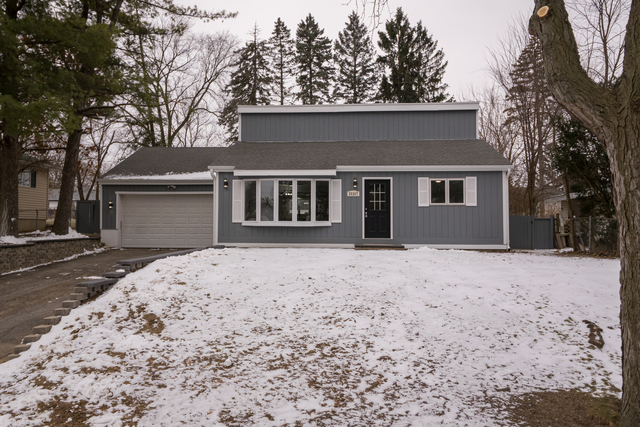 25267 Timber Lane Lake Villa, IL 60046 - Photo 1 of 19 a front view of a house with a yard and garage