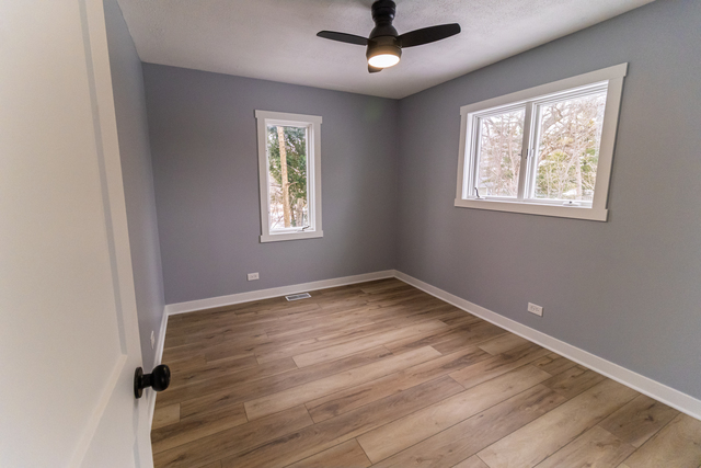 25267 Timber Lane Lake Villa, IL 60046 - Photo 12 of 19 a view of empty room with wooden floor and fan