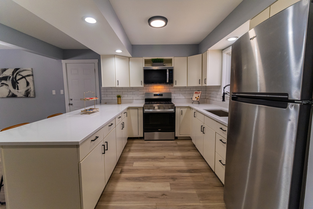 25267 Timber Lane Lake Villa, IL 60046 - Photo 6 of 19 a kitchen with white cabinets and white appliances