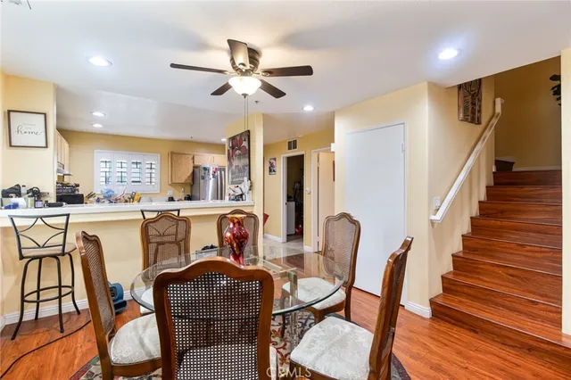a dining room with furniture a chandelier and wooden floor
