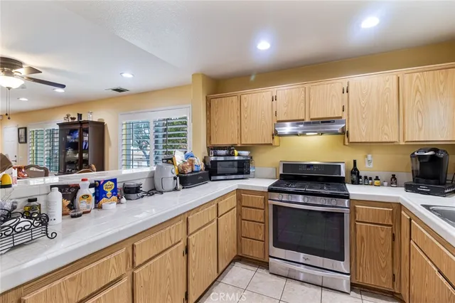 a kitchen with stainless steel appliances granite countertop a stove sink and cabinets