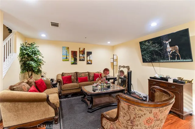 a living room with furniture and a wooden floor