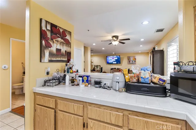 a kitchen with kitchen island a sink and a stove with wooden floor
