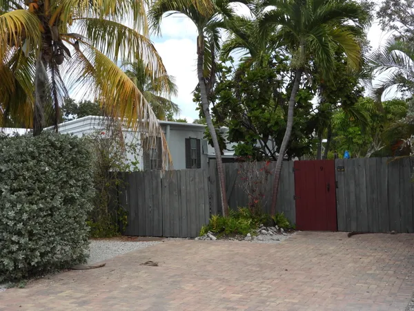 a wooden fence with a palm trees