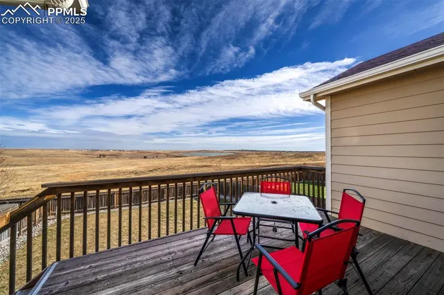 a view of a chairs and table on the roof deck