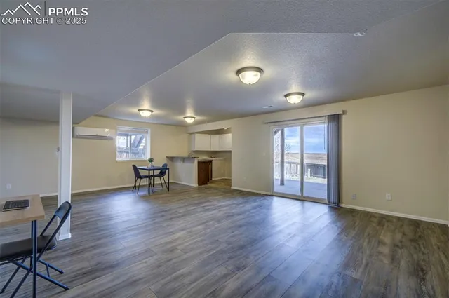a view of a livingroom with furniture and a window