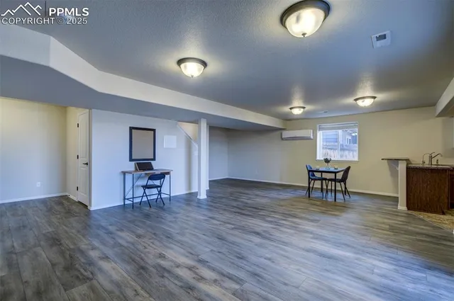 a view of a livingroom with furniture and a kitchen