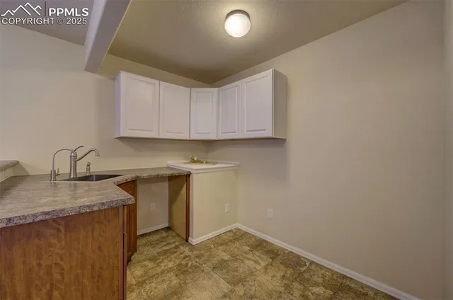 a view of a kitchen with sink and cabinets