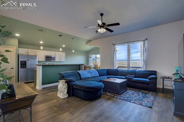 a living room with furniture and a wooden floor