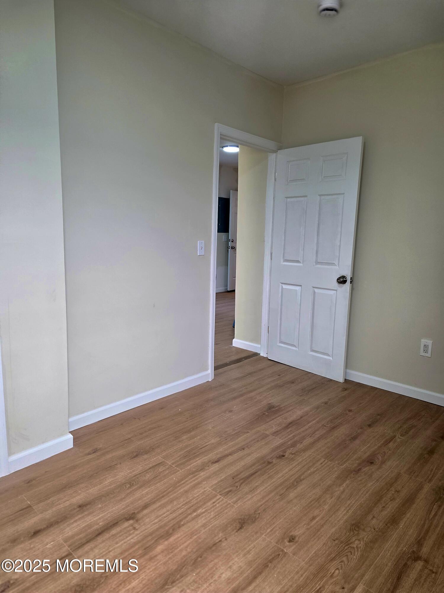 216 Delaware Street Elizabeth Port, NJ 07206 - Photo 14 of 40 a view of an empty room with wooden floor and closet