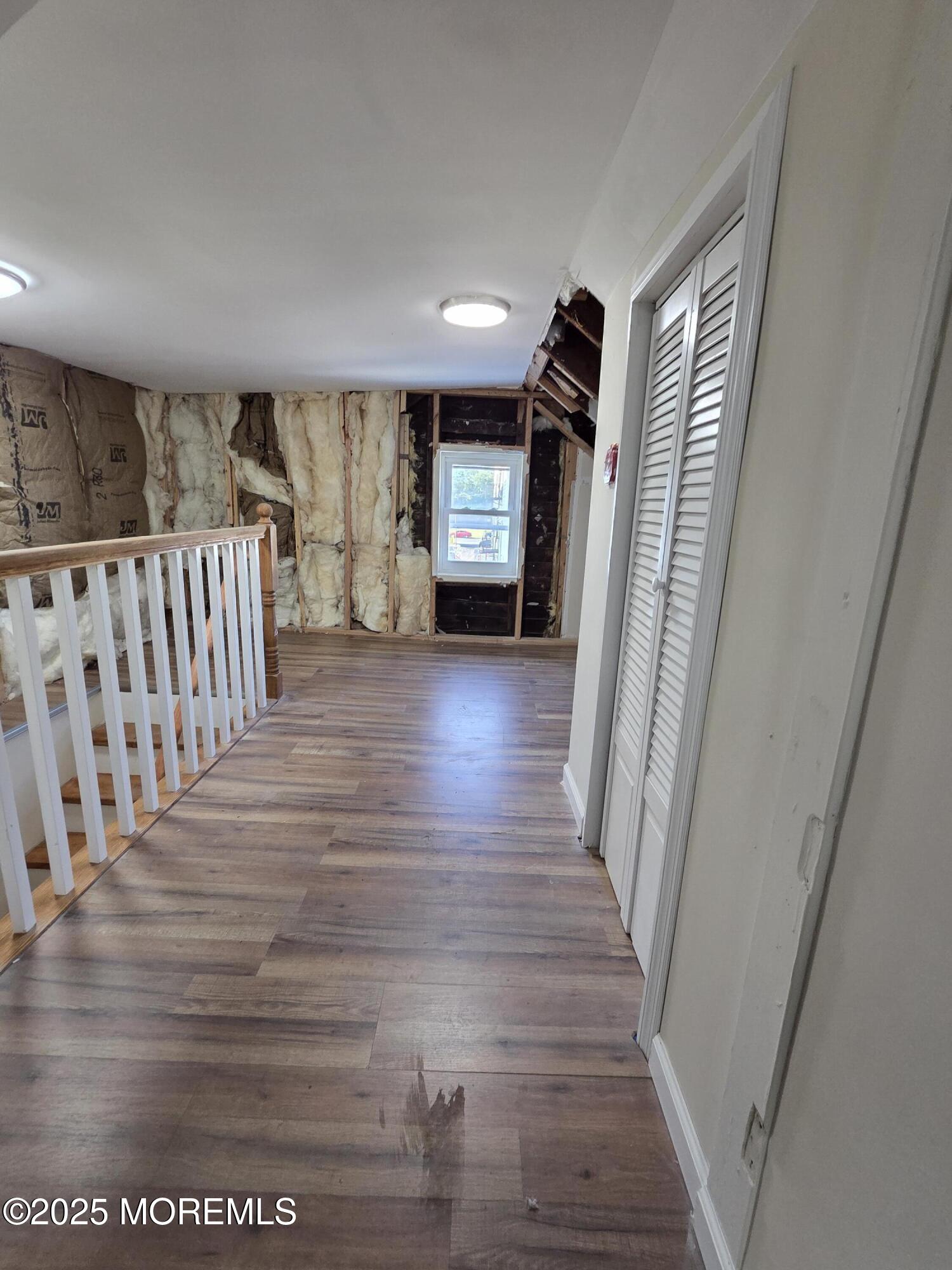 216 Delaware Street Elizabeth Port, NJ 07206 - Photo 32 of 40 a view of a hallway with wooden floor and stairs