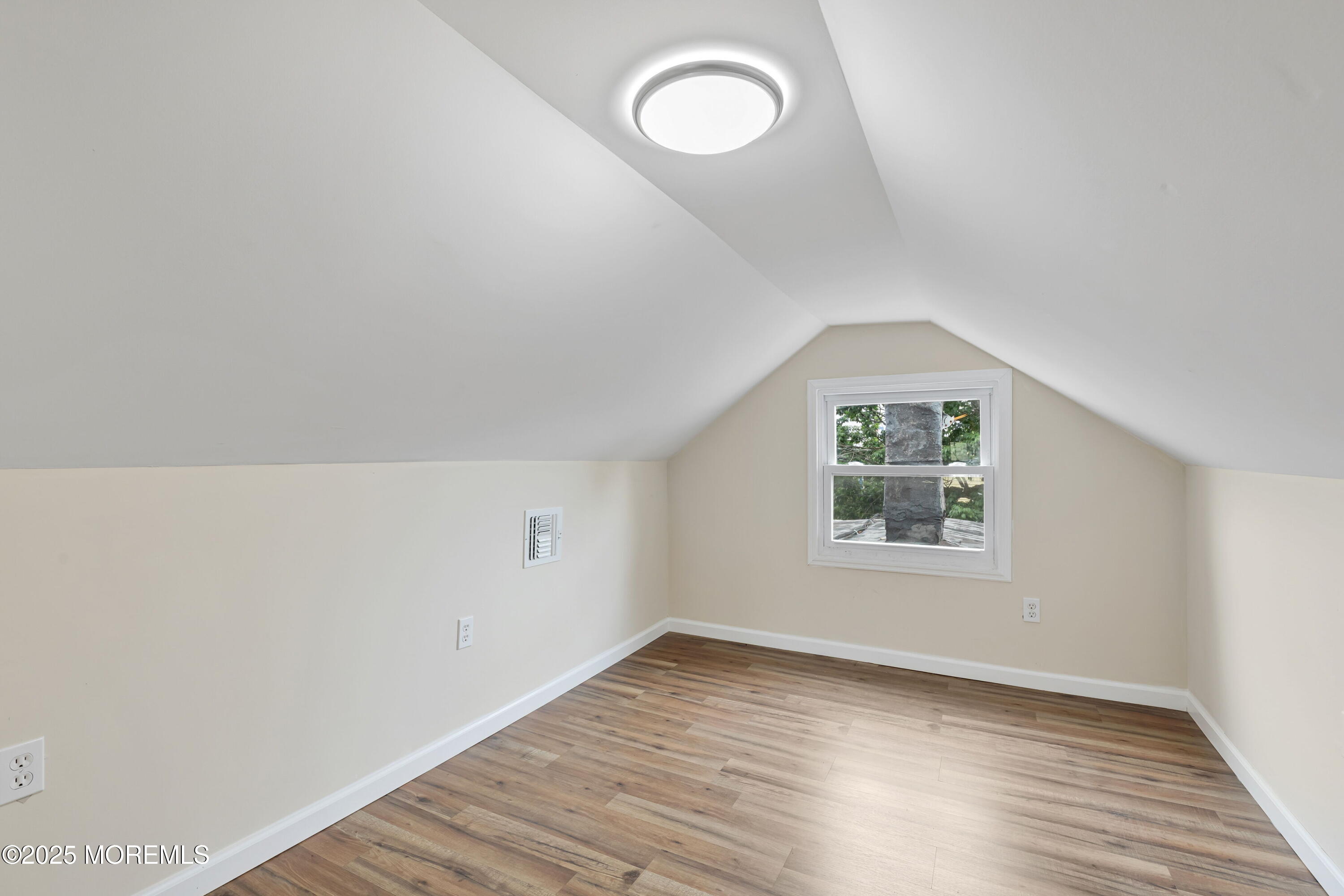 216 Delaware Street Elizabeth Port, NJ 07206 - Photo 34 of 40 an empty room with wooden floor and window