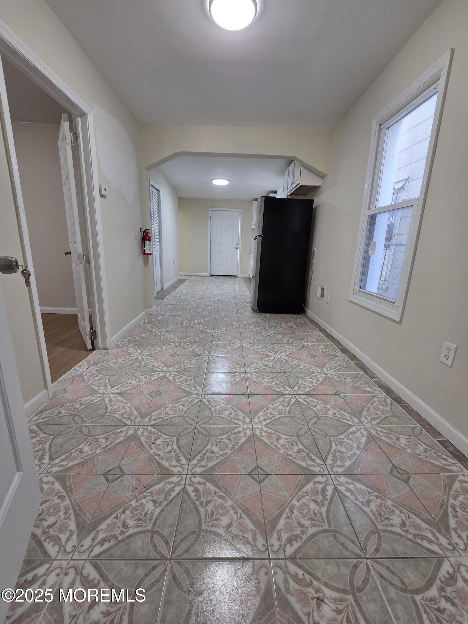 216 Delaware Street Elizabeth Port, NJ 07206 - Photo 4 of 40 a view of a big room with closet and windows