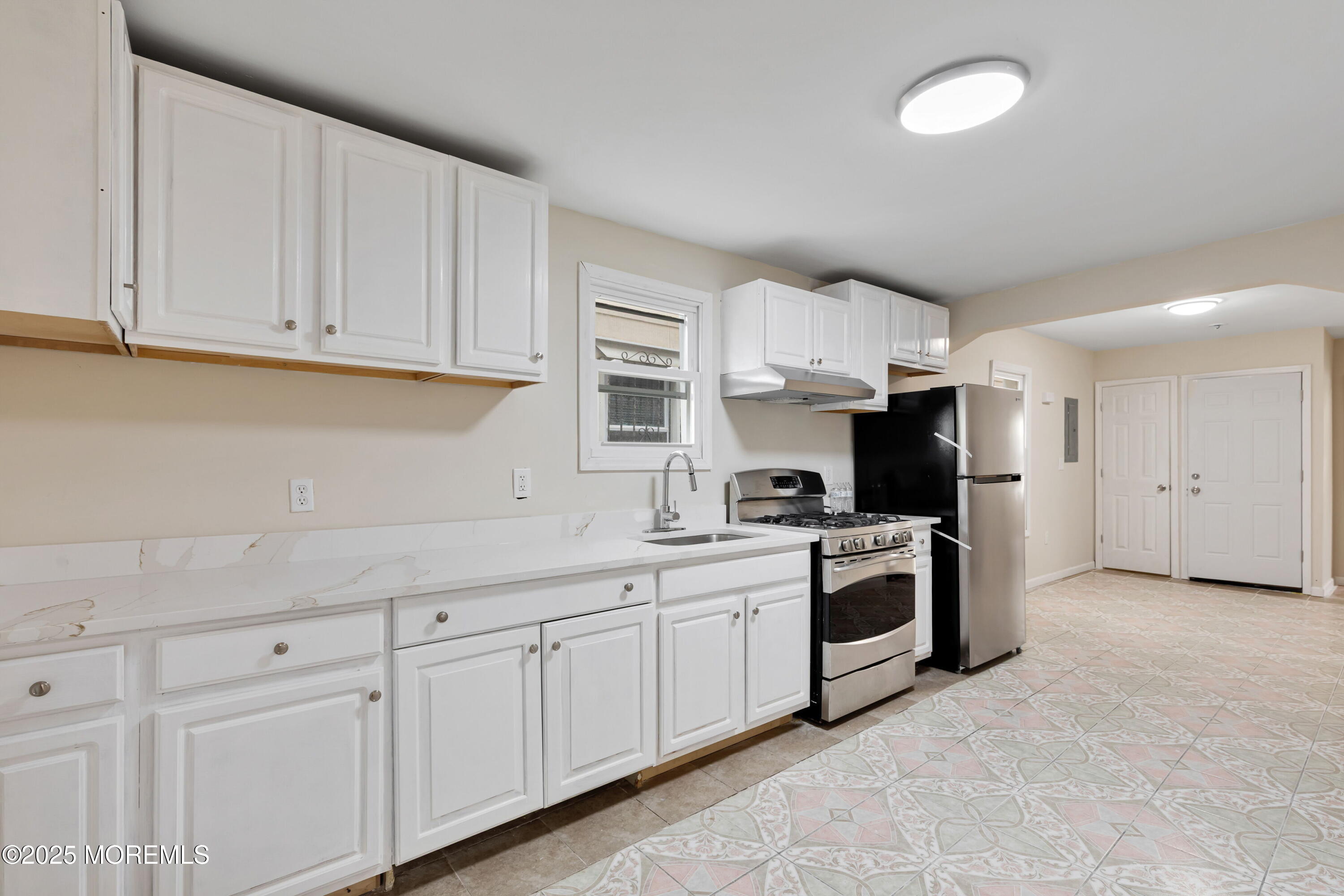 216 Delaware Street Elizabeth Port, NJ 07206 - Photo 6 of 40 a kitchen with cabinets and stainless steel appliances