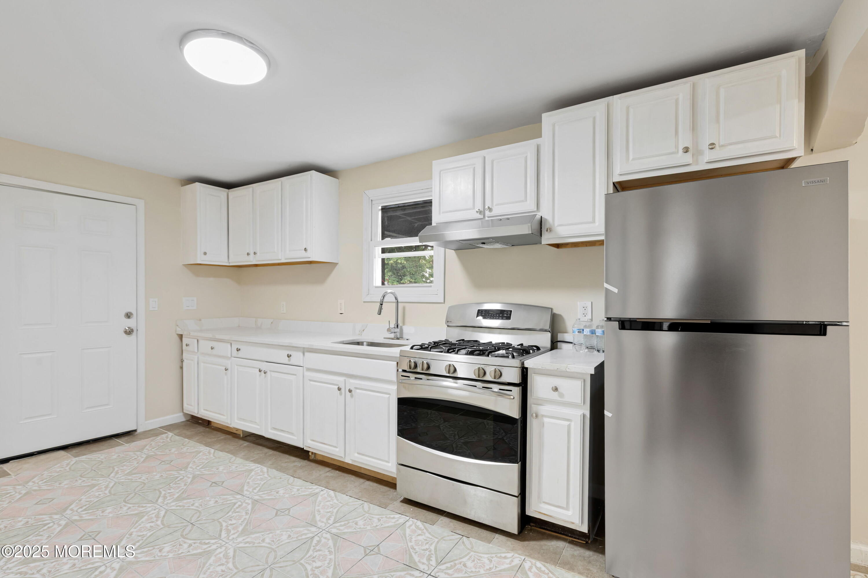 216 Delaware Street Elizabeth Port, NJ 07206 - Photo 7 of 40 a kitchen with a stove sink and refrigerator