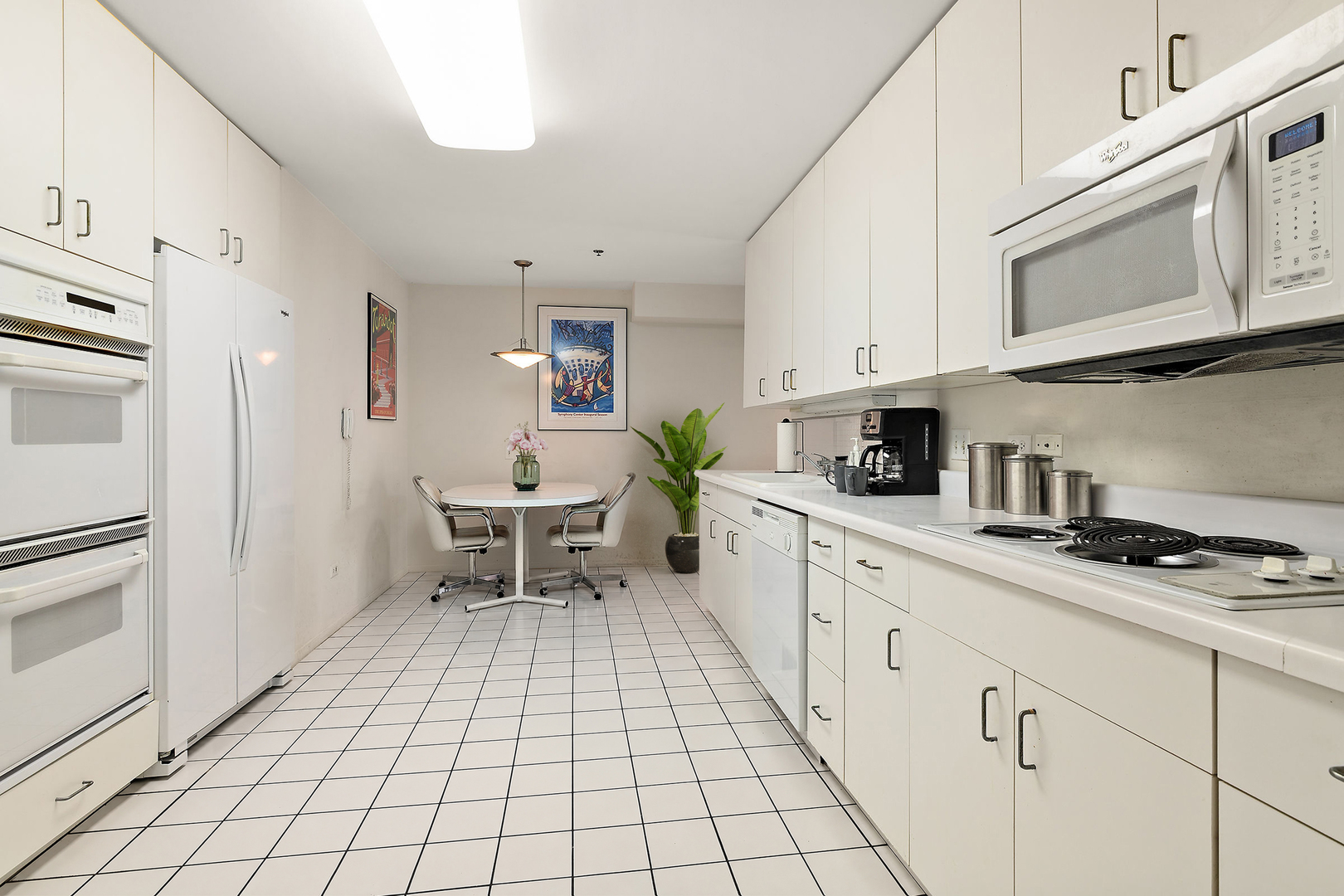 392 Kelburn Road, Unit 122 Deerfield, IL 60015 - Photo 5 of 22 a kitchen with stainless steel appliances white cabinets and white appliances