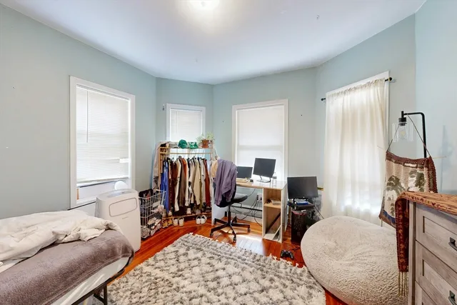 a bedroom with furniture and a window