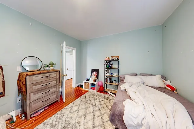 a bed room with a bed and a flat tv screen