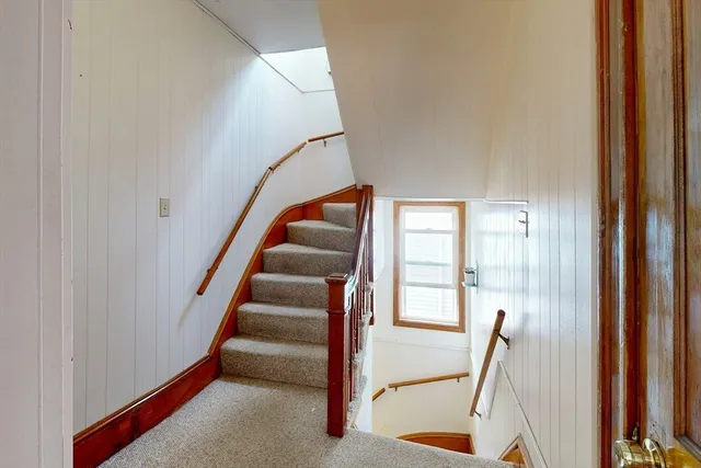 a view of entryway with wooden floor and windows