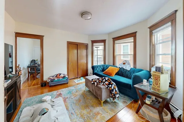 a bedroom with furniture and a large window
