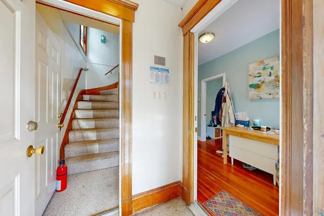 a view of hallway with wooden floor and stairs