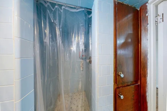 a bathroom with a glass shower door
